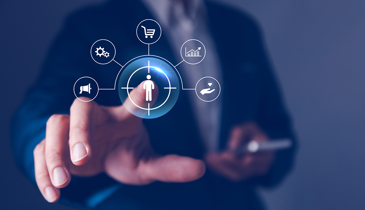 A multichannel ecommerce seller reaches a hand toward a graphic representation of customer-centric selling, shown as a customer surrounded by a shopping cart, hand holding a heart, gears, a megaphone, and business graph.