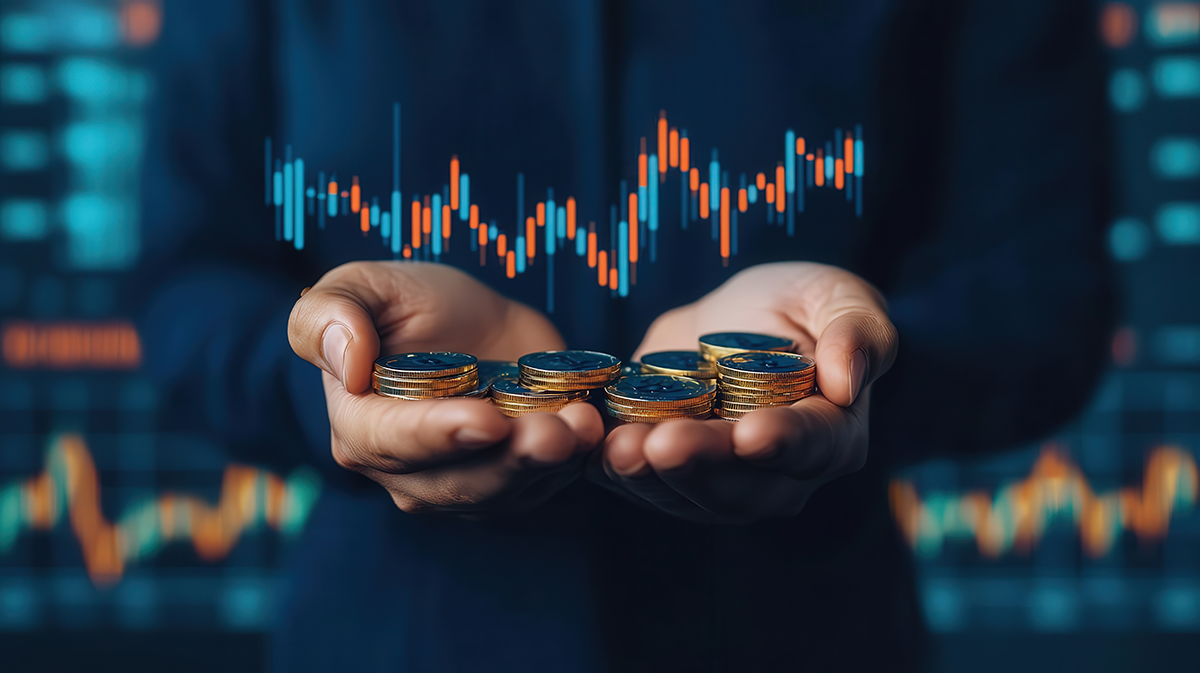 A businessperson holds out their hands filled with coins representing cost to serve. Business graphics float above the hands and in the background of the image to represent changes in profit margins.